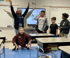 Students and teaching artist engaging in classroom arts