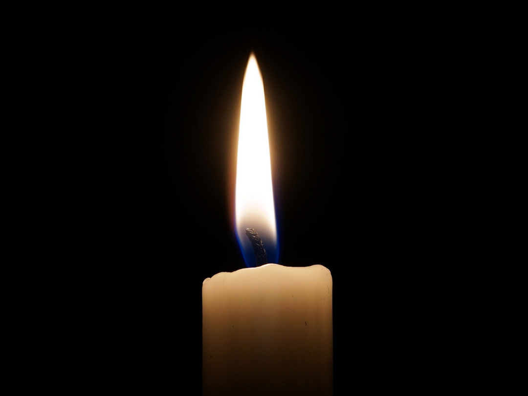 A candle flame against a black background