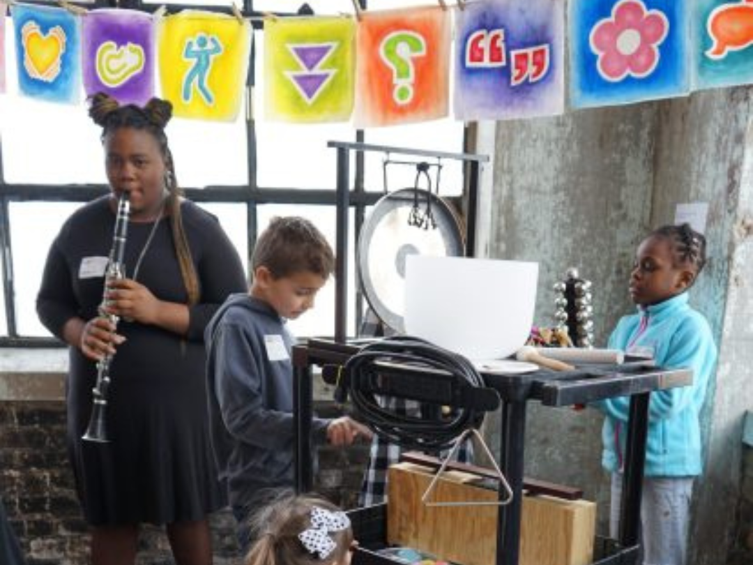 Students playing musical instruments in CAPE Gallery